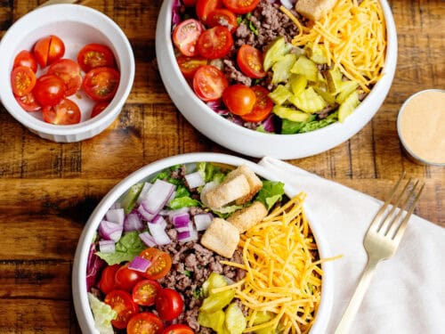 2 bowls of Cheeseburger Salad with toppings