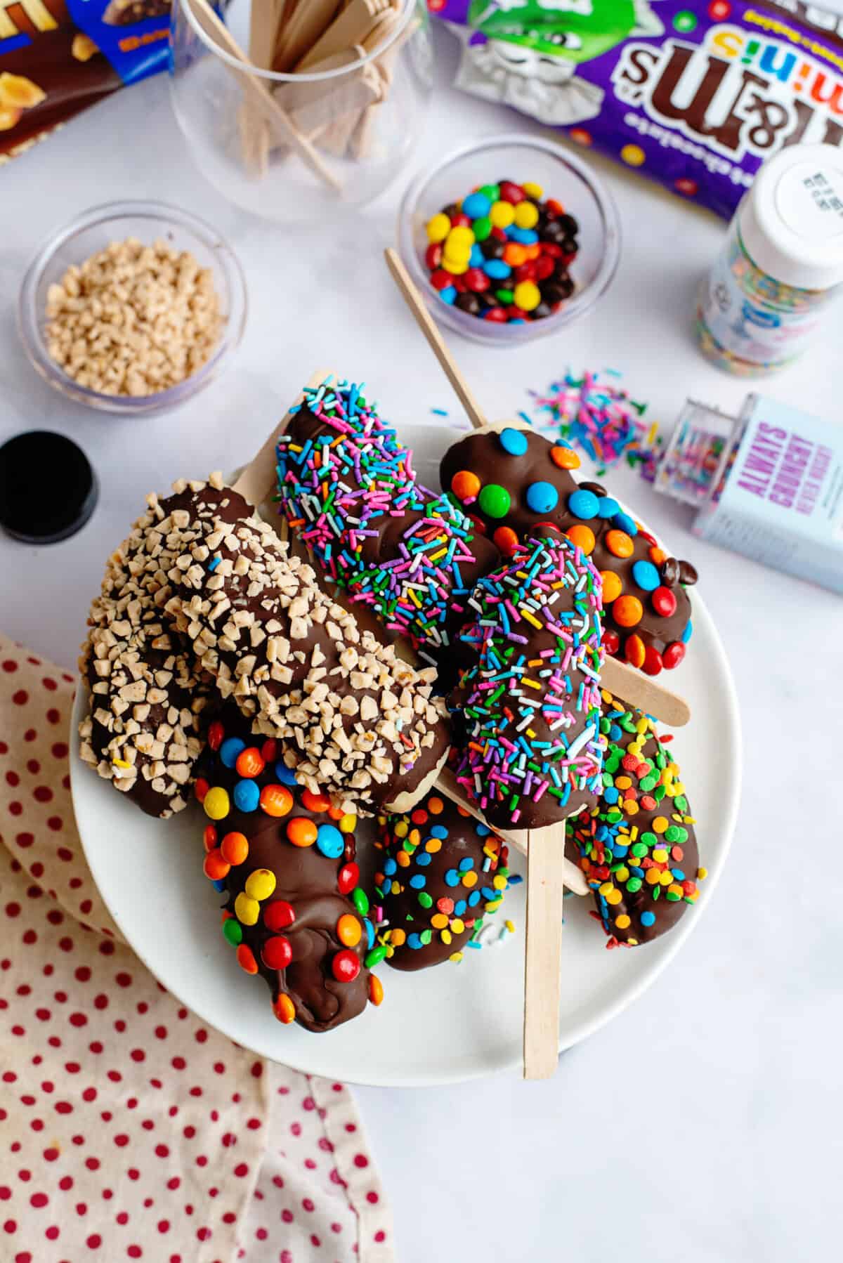 A plate of a variety of chocolate covered bananas