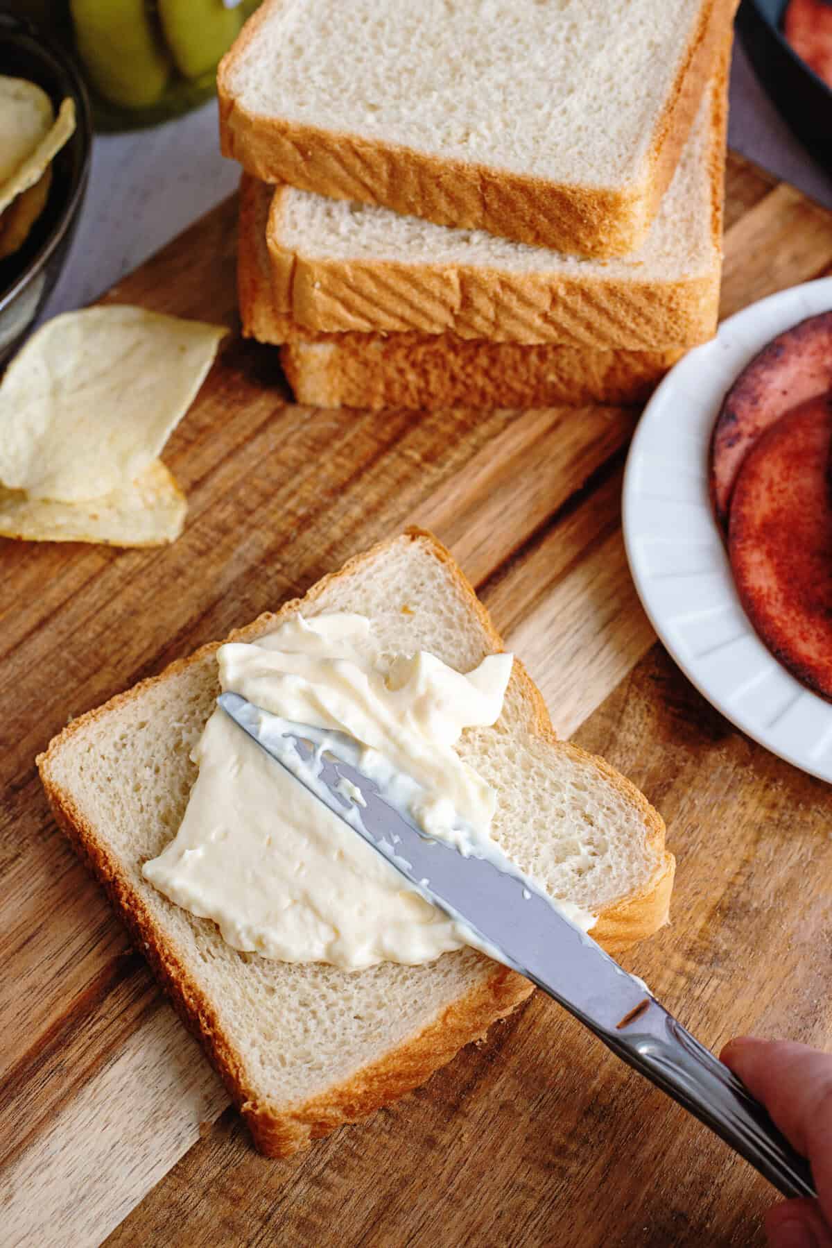 Adding mayo to a slice of bread