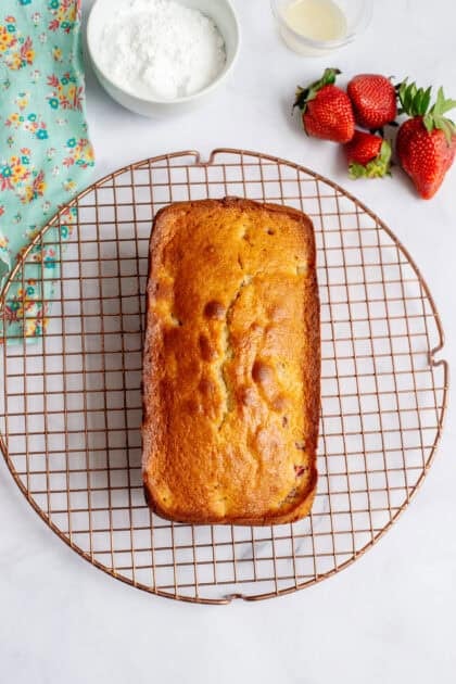 Baked strawberry bread on a wire rack