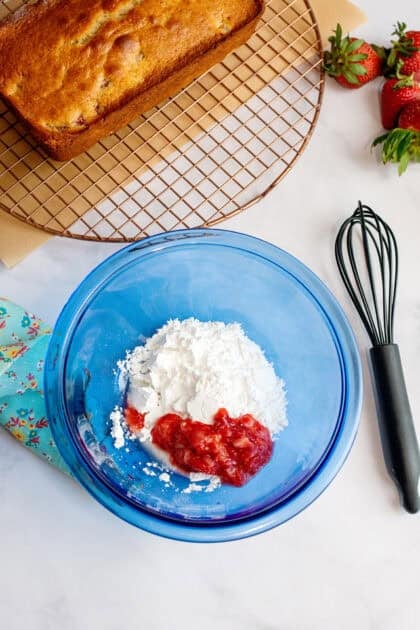 powdered sugar and mashed berries in a small bowl.
