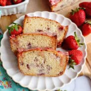 A plate with 3 slices of strawberry bread with glaze