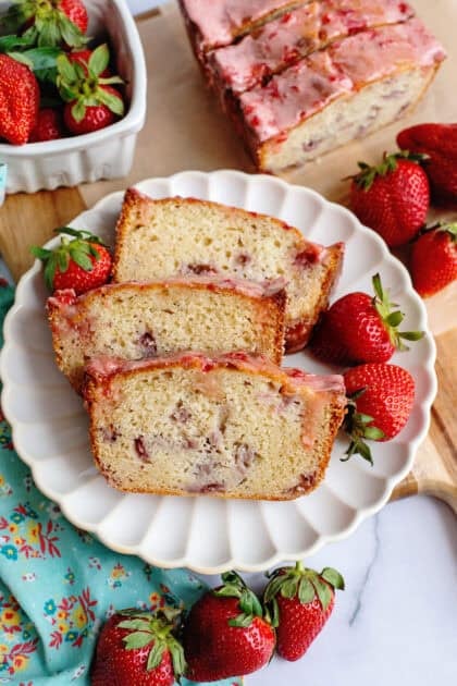 A plate with 3 slices of strawberry bread with glaze