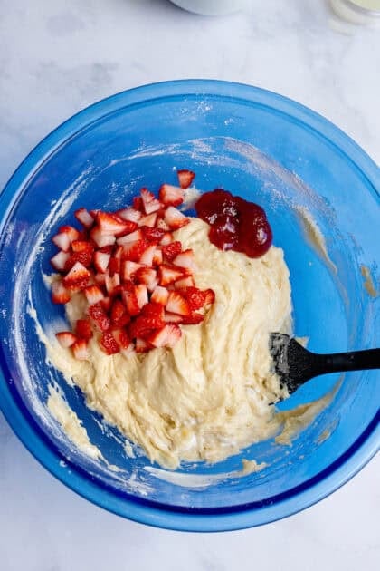 Adding strawberries to the strawberry mixture