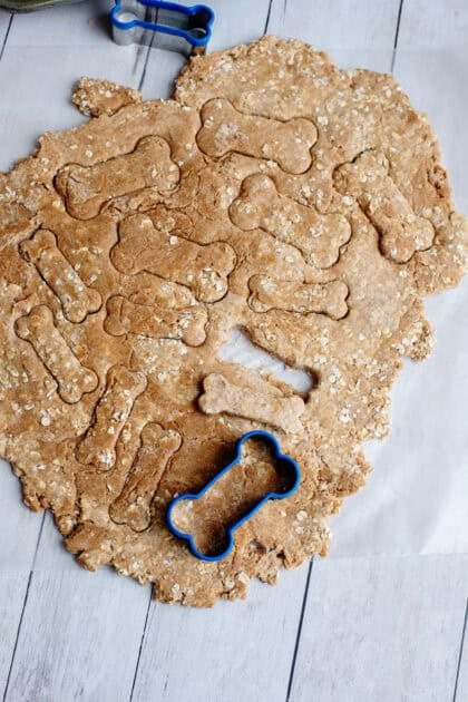 Cutting out the doggie biscuits with a bone-shaped cookie cutter