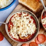 Pizza soup with melted mozzarella cheese