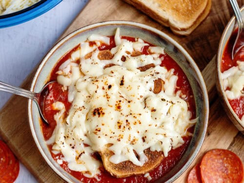 Pizza soup with melted mozzarella cheese