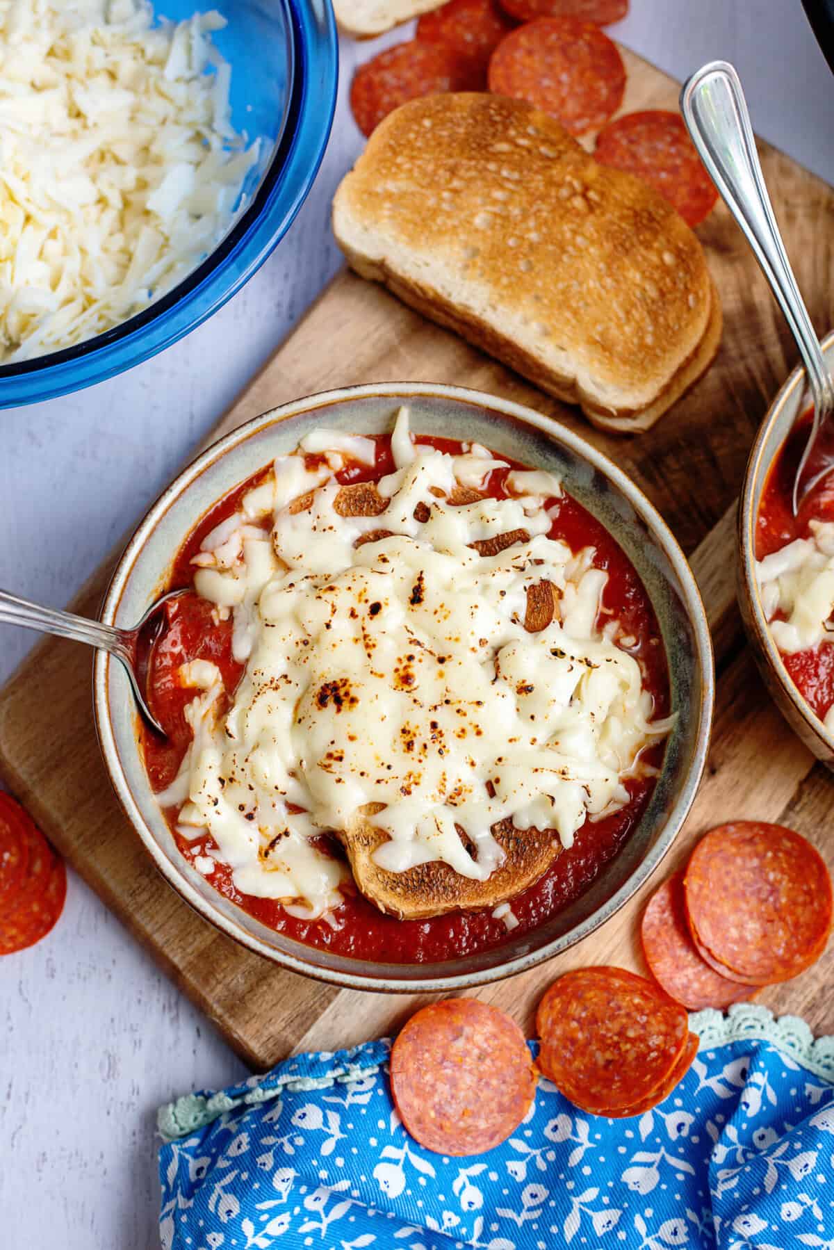 Pizza soup with melted mozzarella cheese