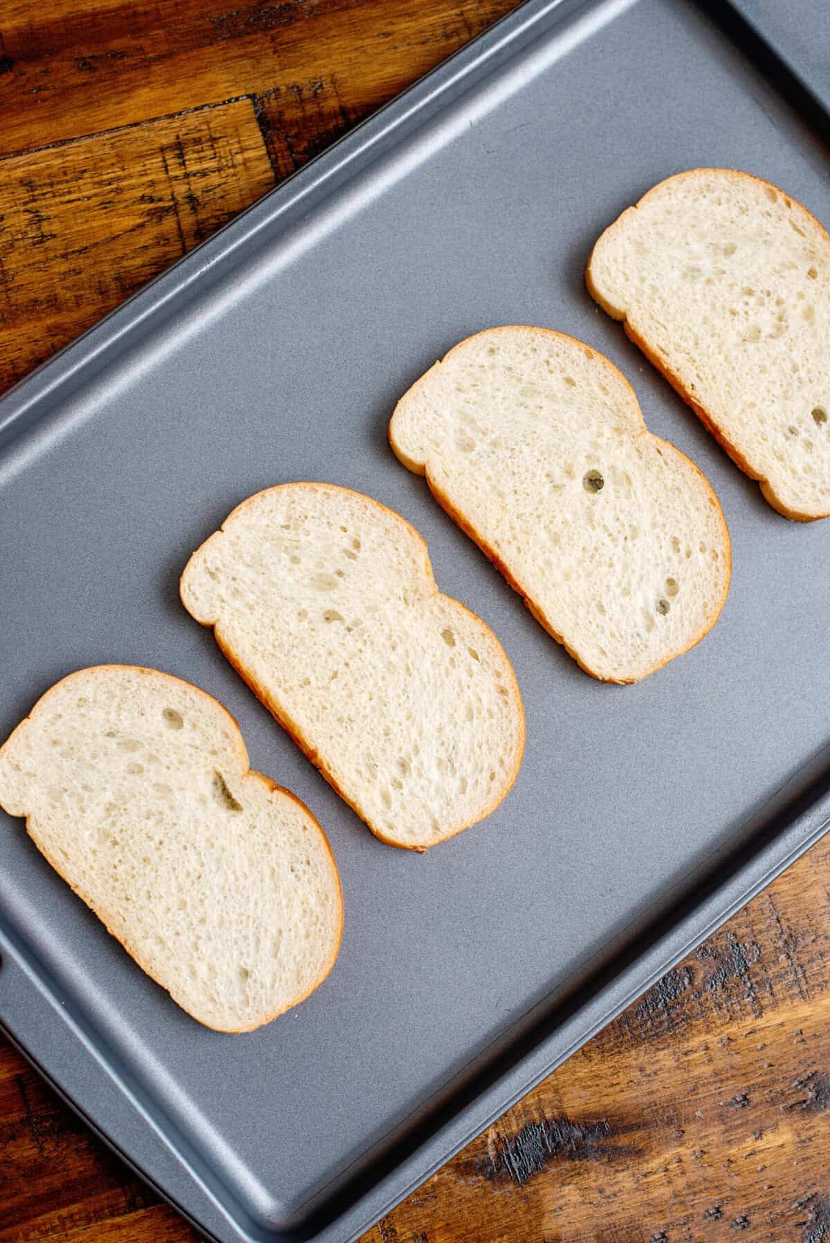 Sliced toast on a baking sheet