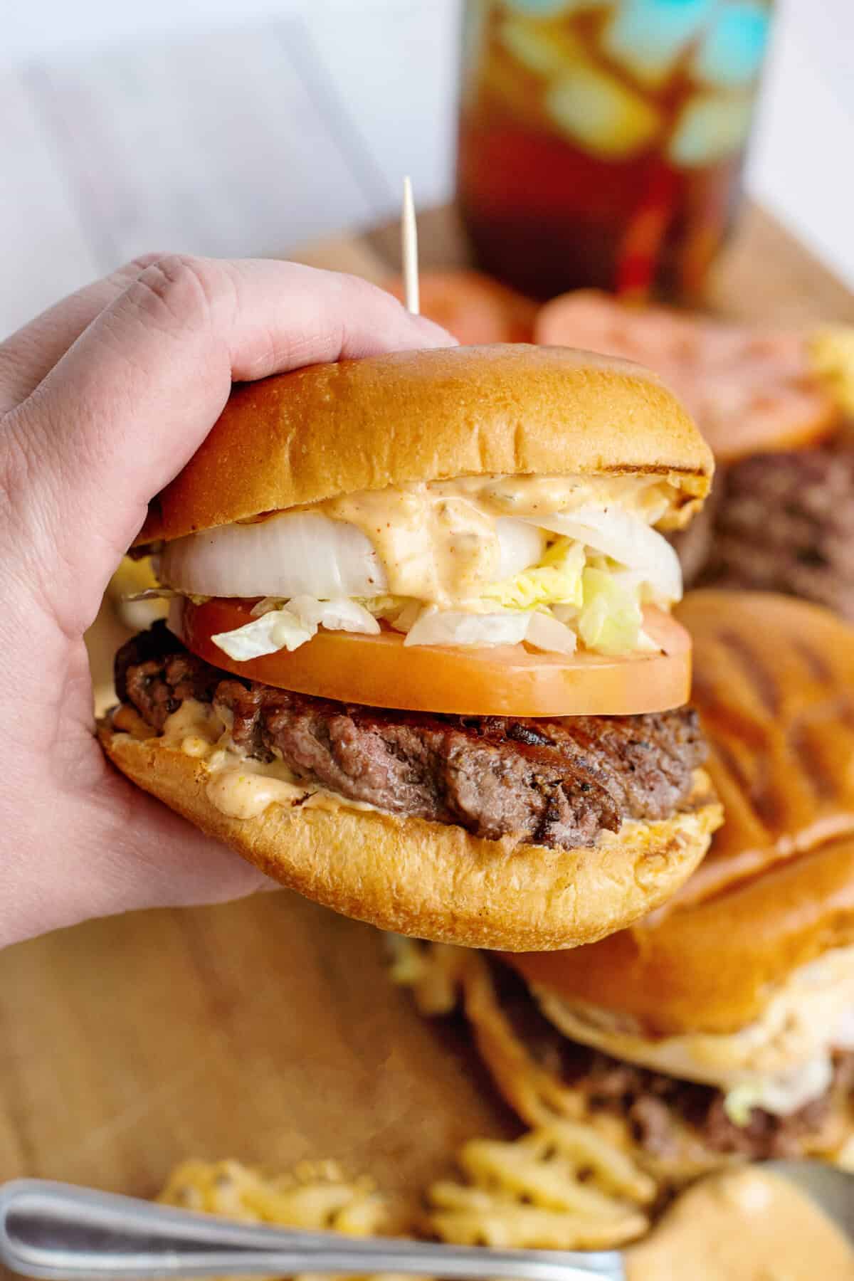 Holding a finished smash burger