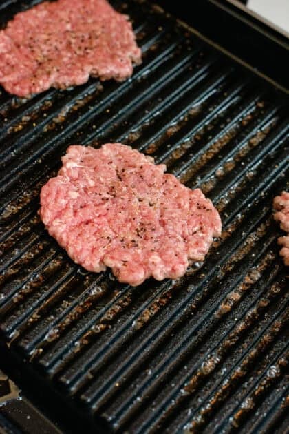 Smashed burger patty cooking on the griddle