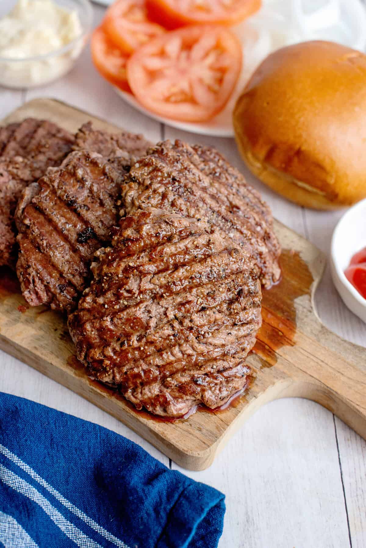 Cooked smash burger patties on a cutting board