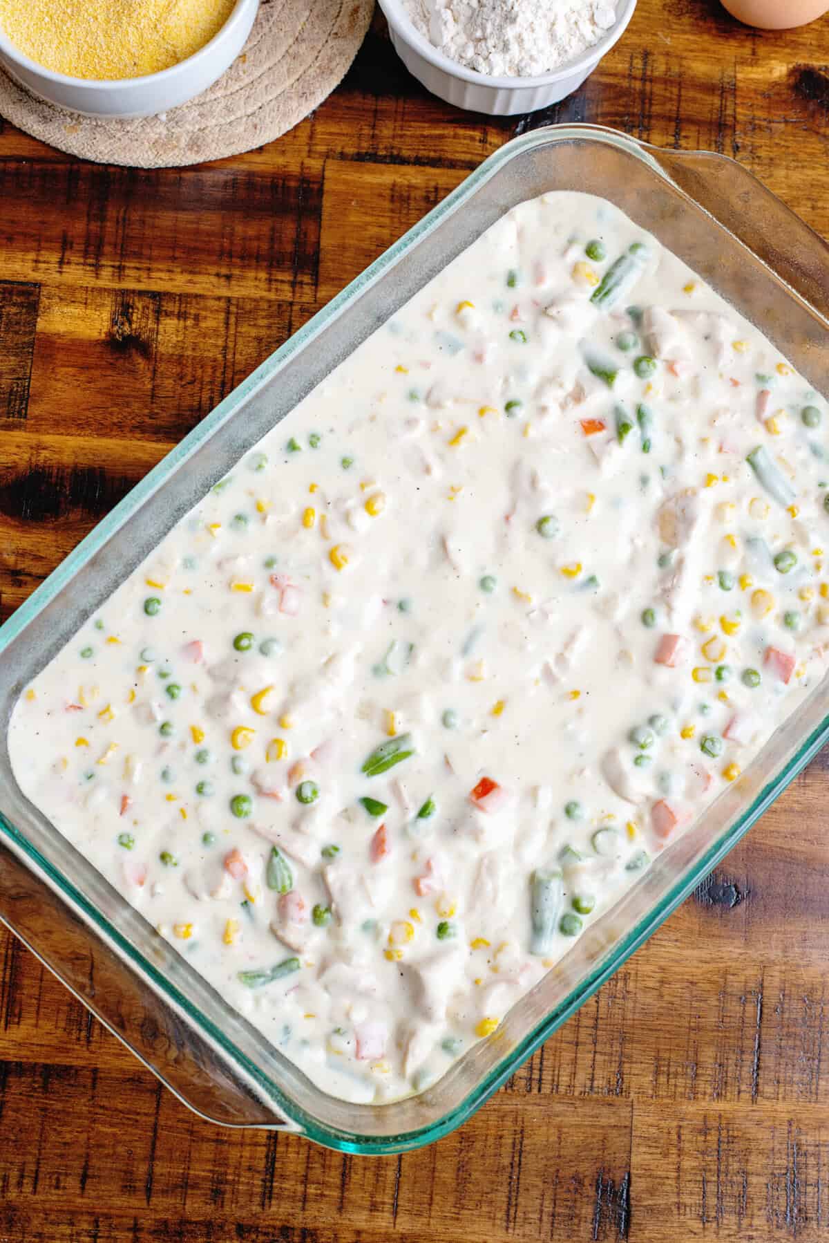Chicken pot pie filling in a casserole dish.