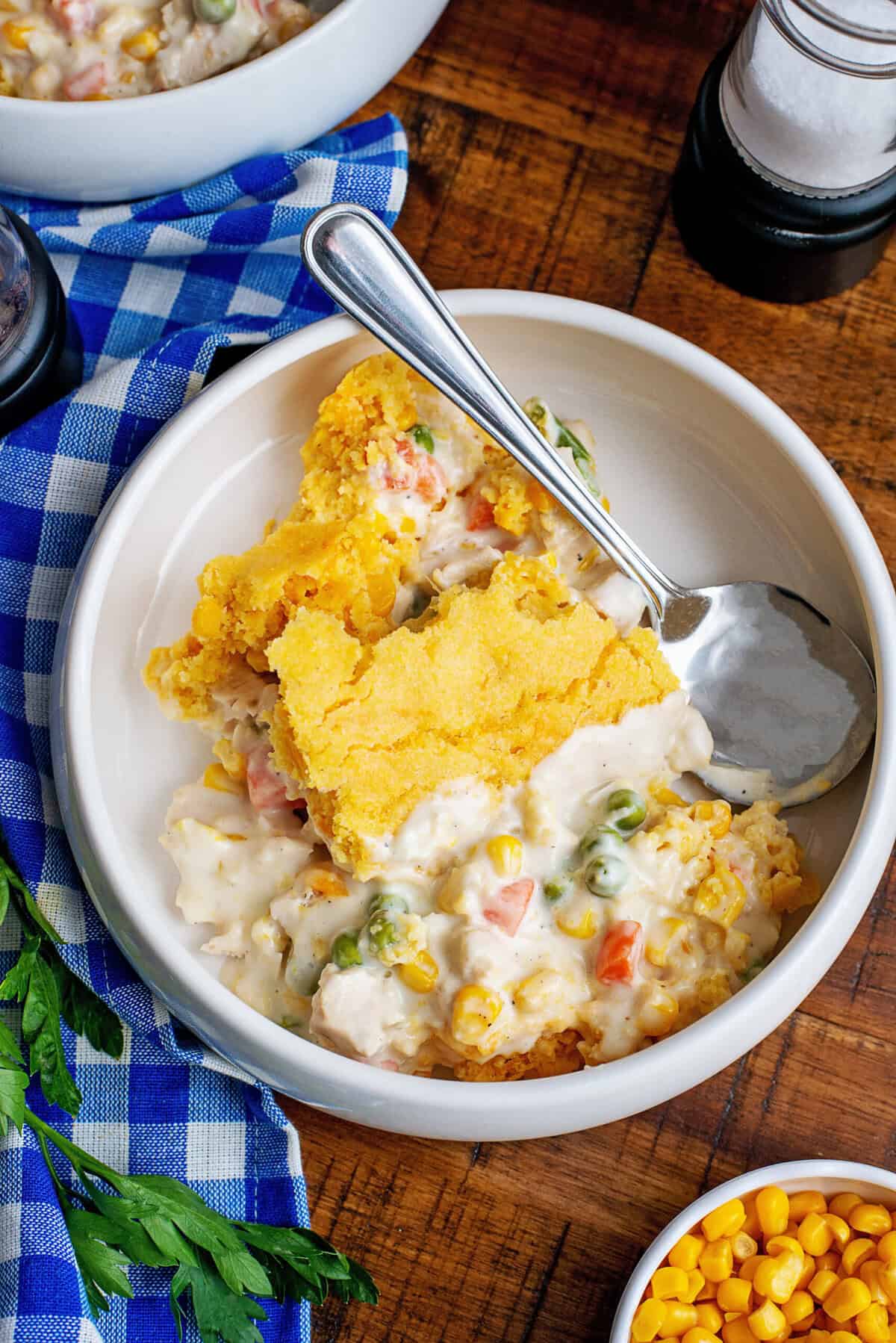 A serving of cornbread chicken pot pie in a white bowl.