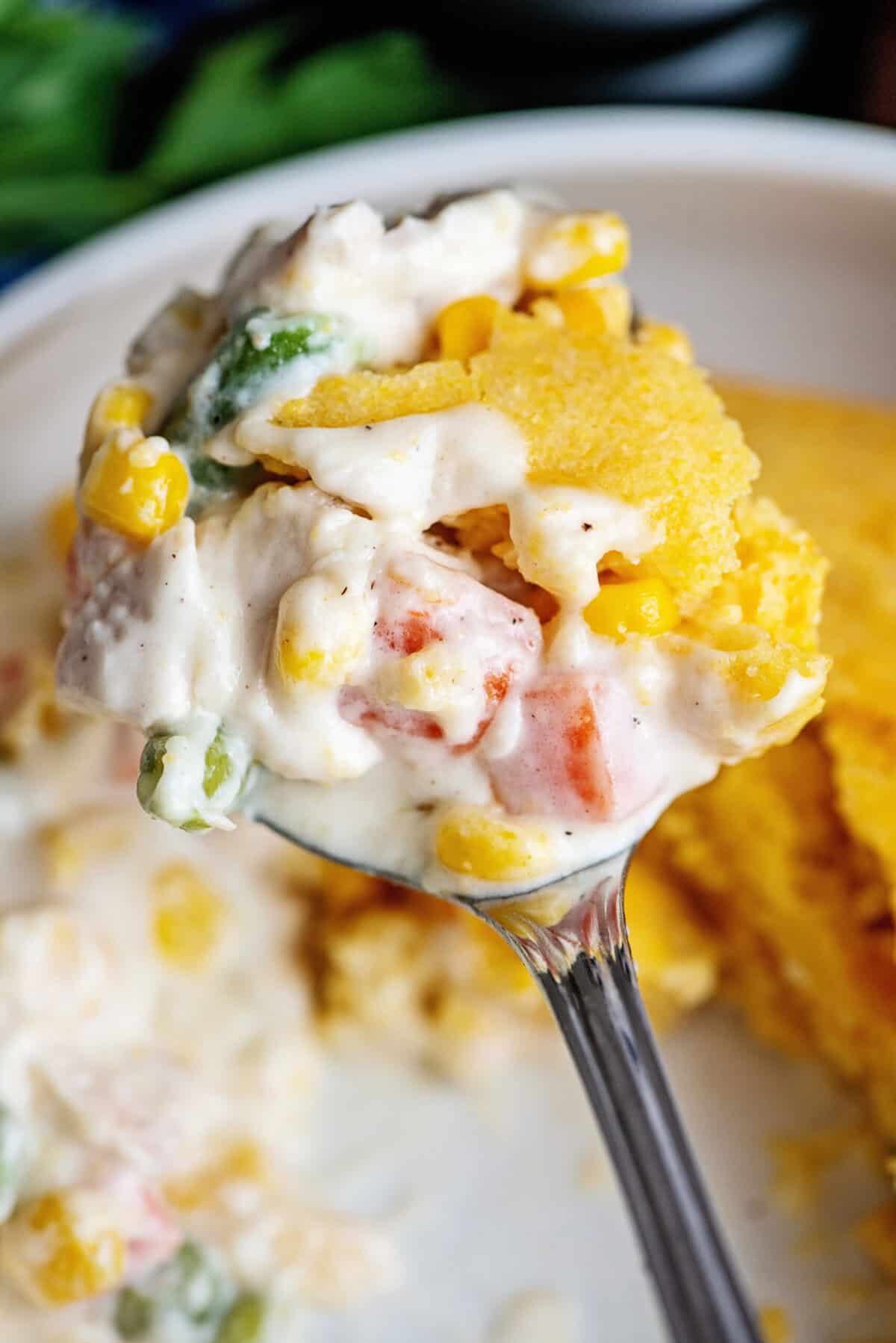 A spoonful of cornbread chicken pot pie.