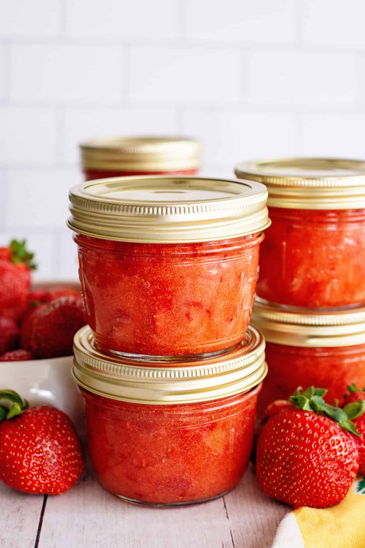 Side view of sealed mason jars of easy strawberry freezer jam