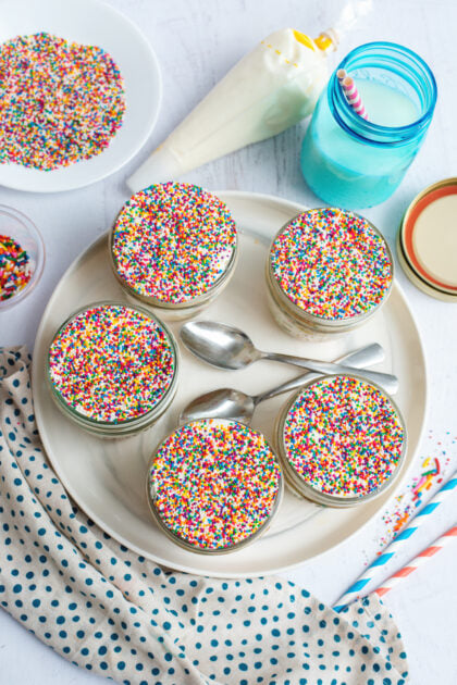Top-down view of a tray of Funfetti dot cake jars