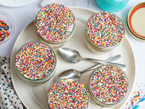 Top-down view of a tray of Funfetti dot cake jars