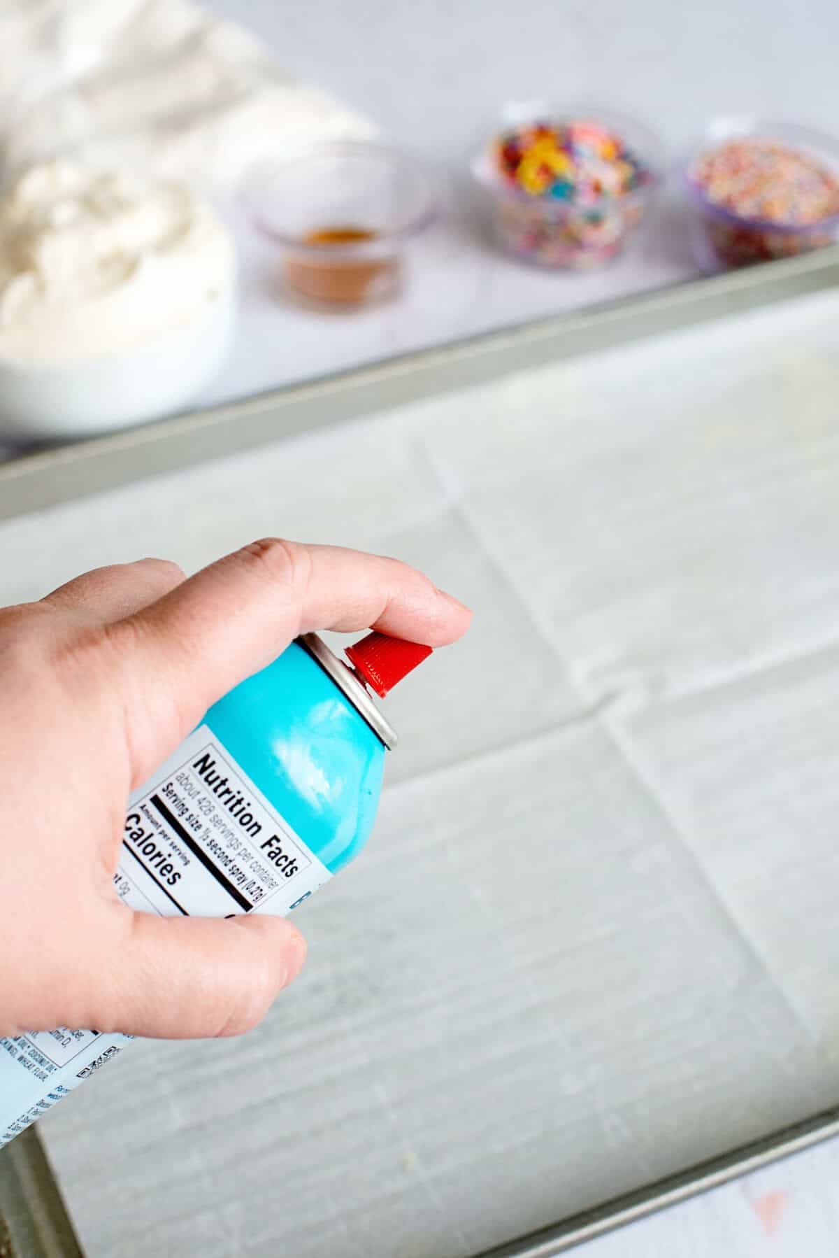 Lining a baking sheet with parchment paper and non-stick spray