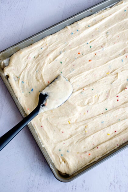 Spreading the Funfetti dot cake jar batter into the baking sheet