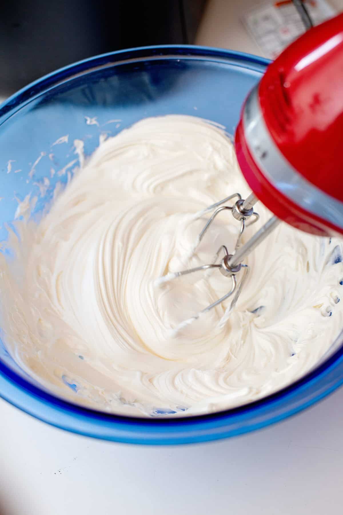 Using a mixer to whip the Funfetti dot cake jar frosting