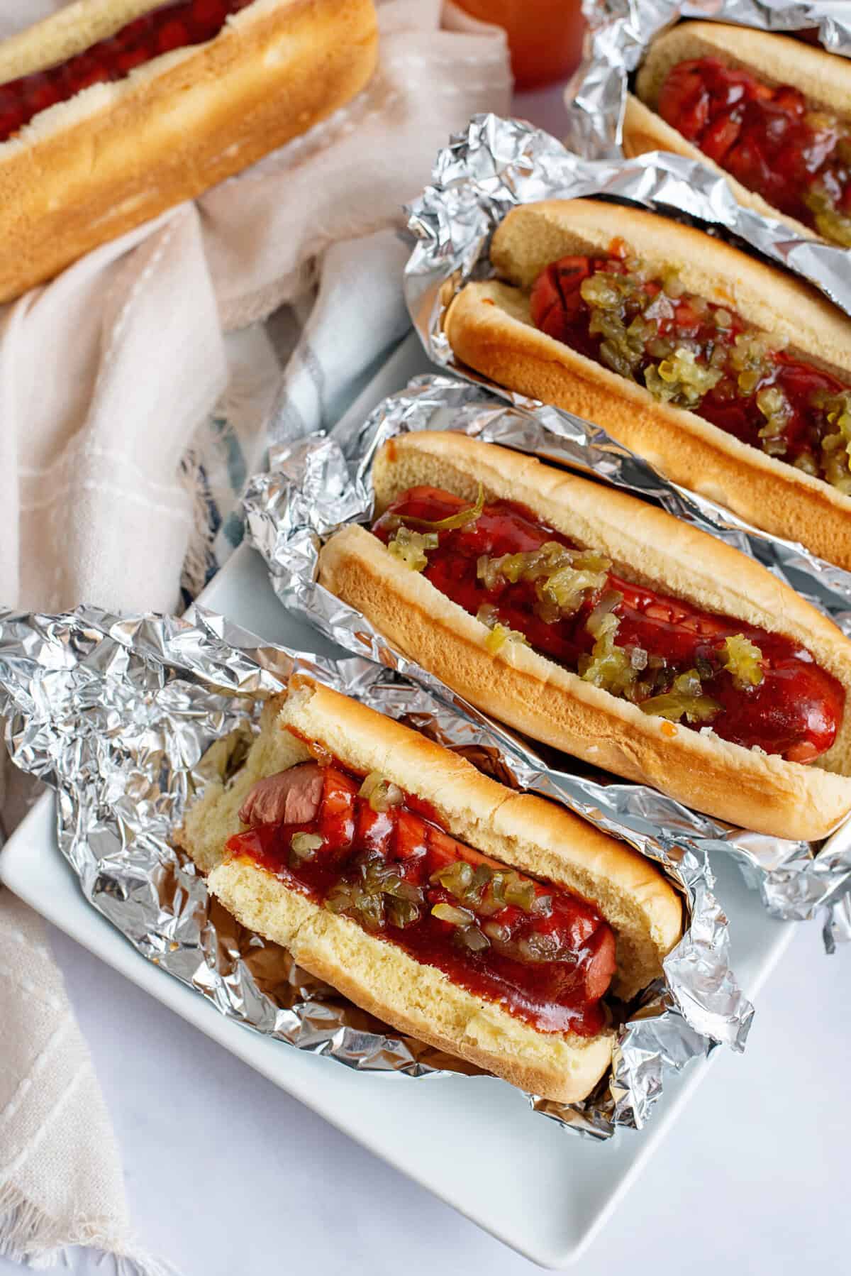 Copycat J Dawgs Hot Dogs lined up on tin foil