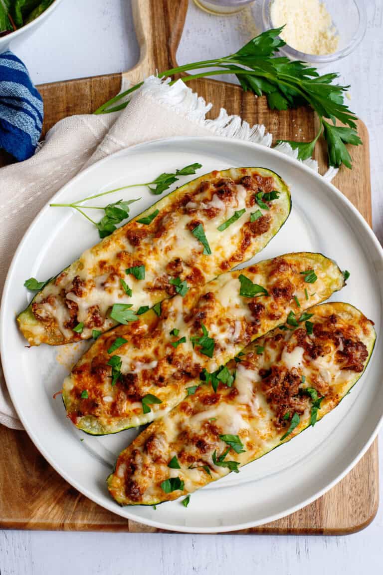 A plate with 3 zucchini stuffed boats