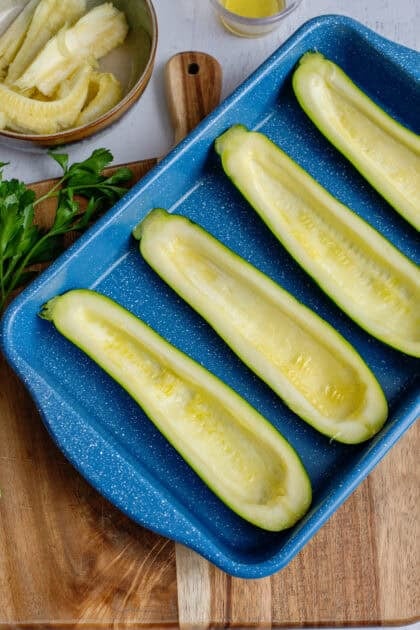 Zucchini halves on a baking sheet