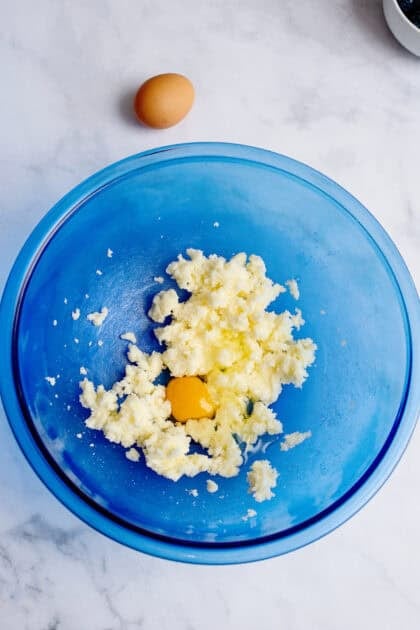 eggs, vanilla, and sugar added to the mixing bowl of blueberry coffee cake ingredients