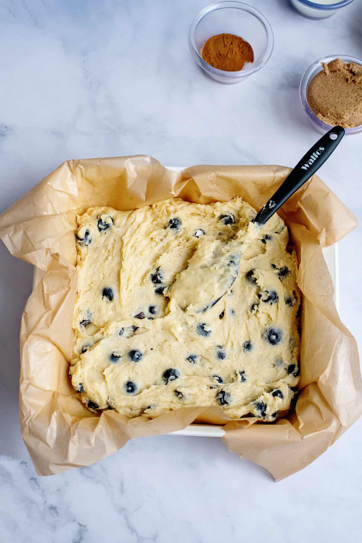 Blueberry coffee cake batter in a baking pan