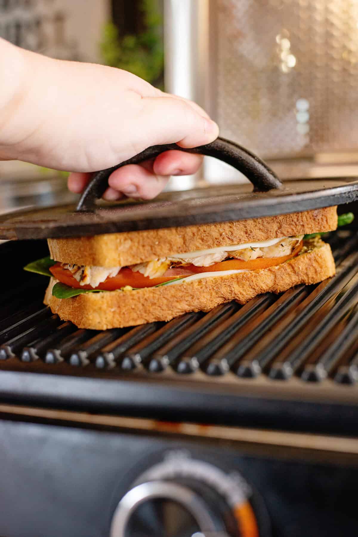 Pressing a pesto chicken panini