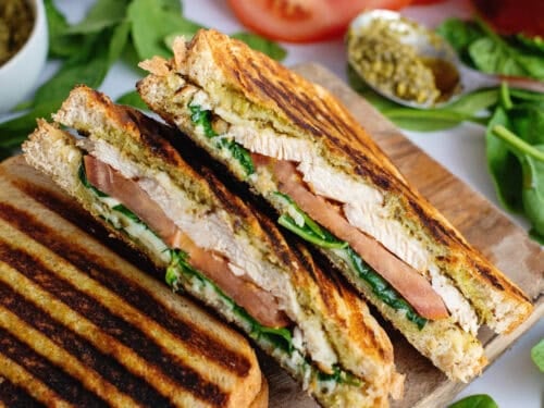 Chicken pesto paninis on a cutting board