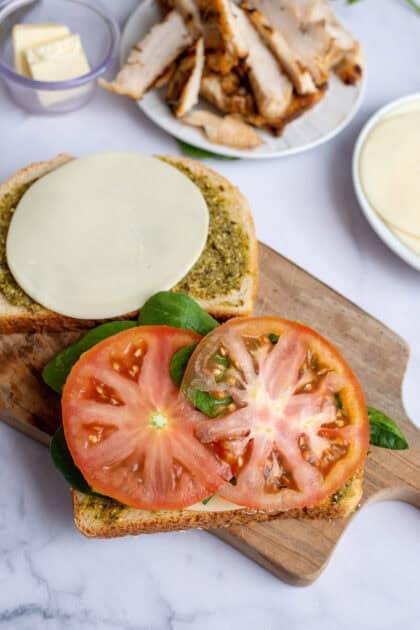 Adding tomato slices to the bread slices