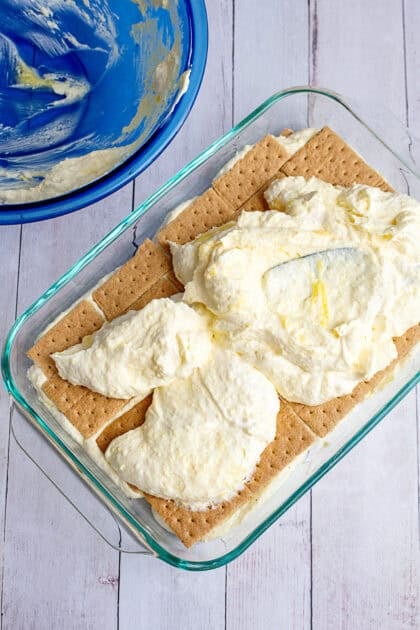 Adding the remaining vanilla pudding mix to on the graham cracker base