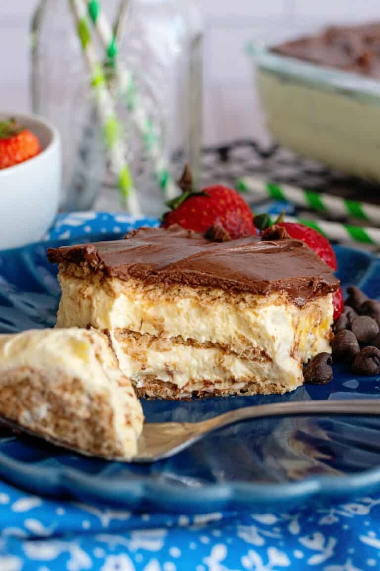 Chocolate eclair icebox cake on a blue plate with a fork.