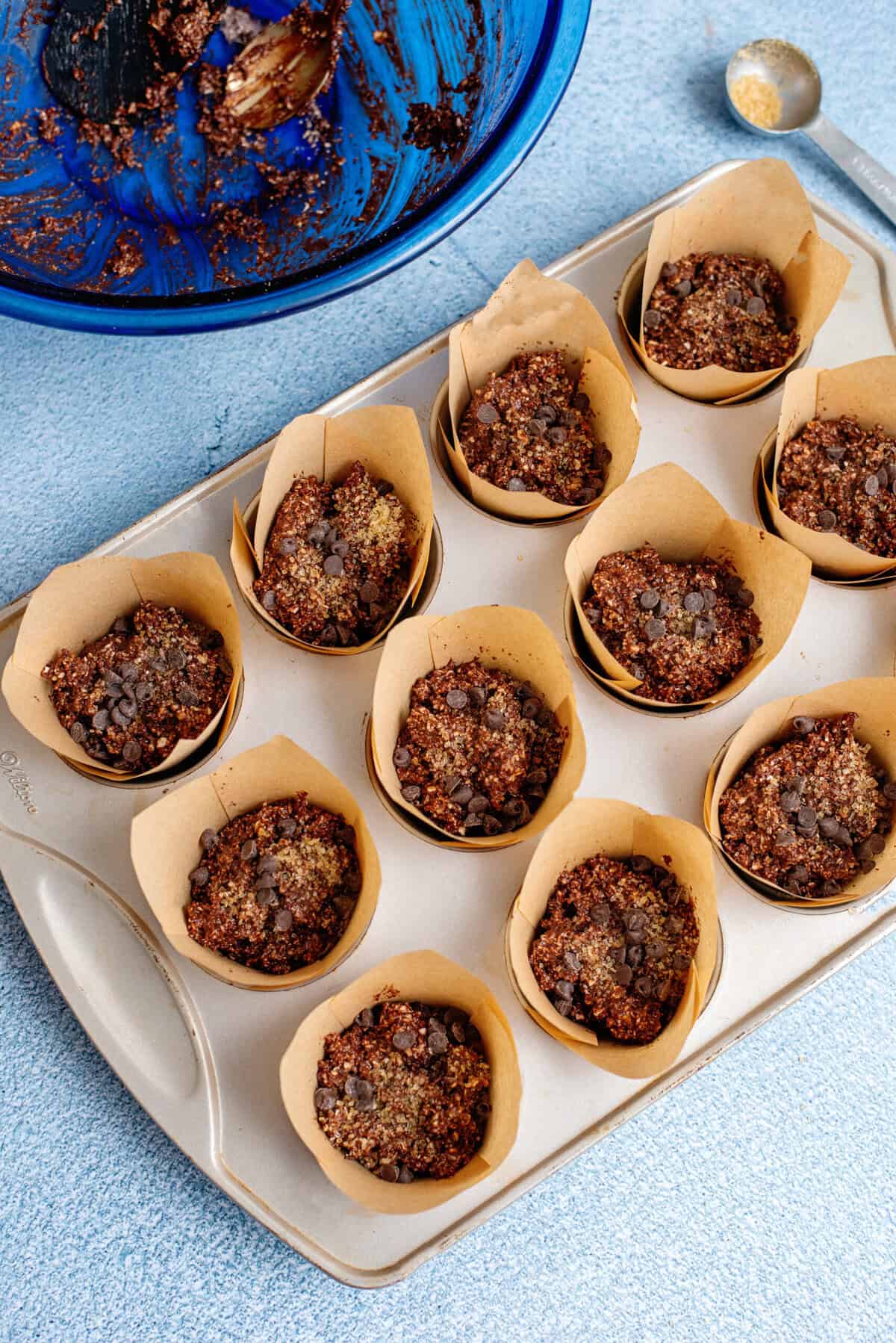 Adding the chocolate cottage cheese muffin batter to a muffin pan