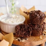 A tray with chocolate cottage cheese muffins next to a bowl of cottage cheese