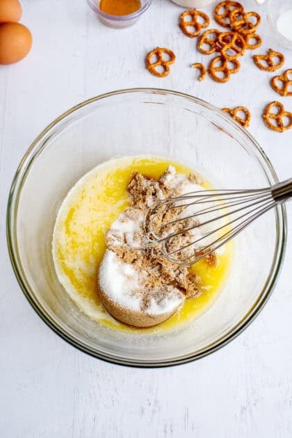 melted butter, granulated sugar, eggs, and brown sugar in a bowl