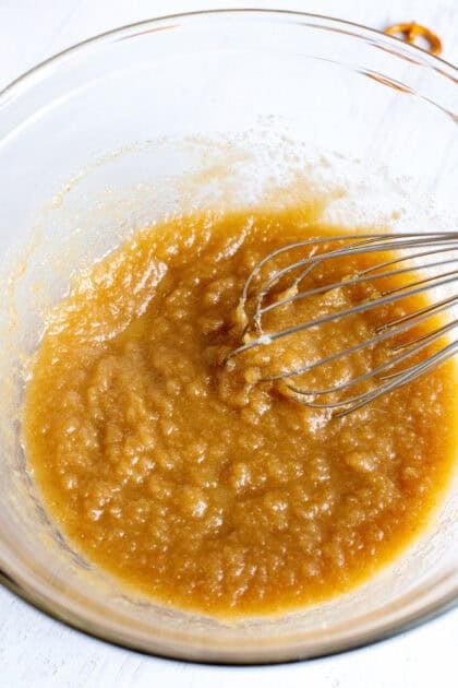 Stirring the wet ingredients for salted caramel pretzel brownies in a bowl