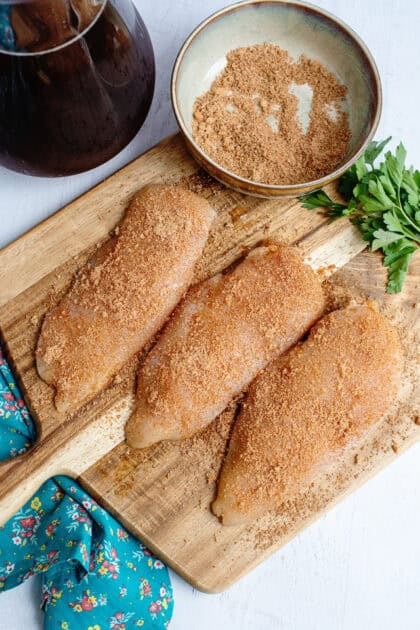 Coating the raw chicken in the dry seasonings