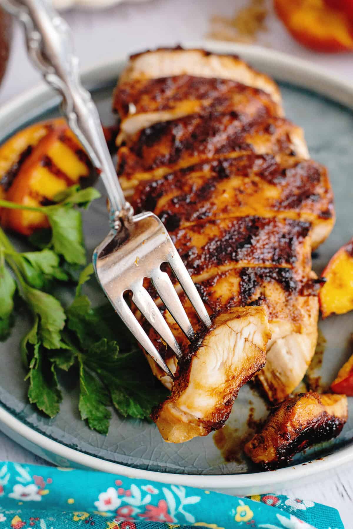 Taking a piece of the sliced sweet tea brine chicken with a fork