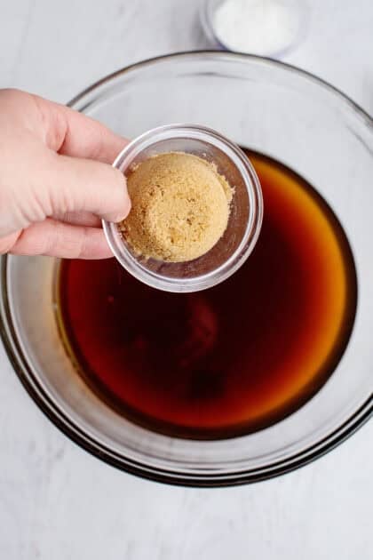 Adding brown sugar to the cooled sweet tea