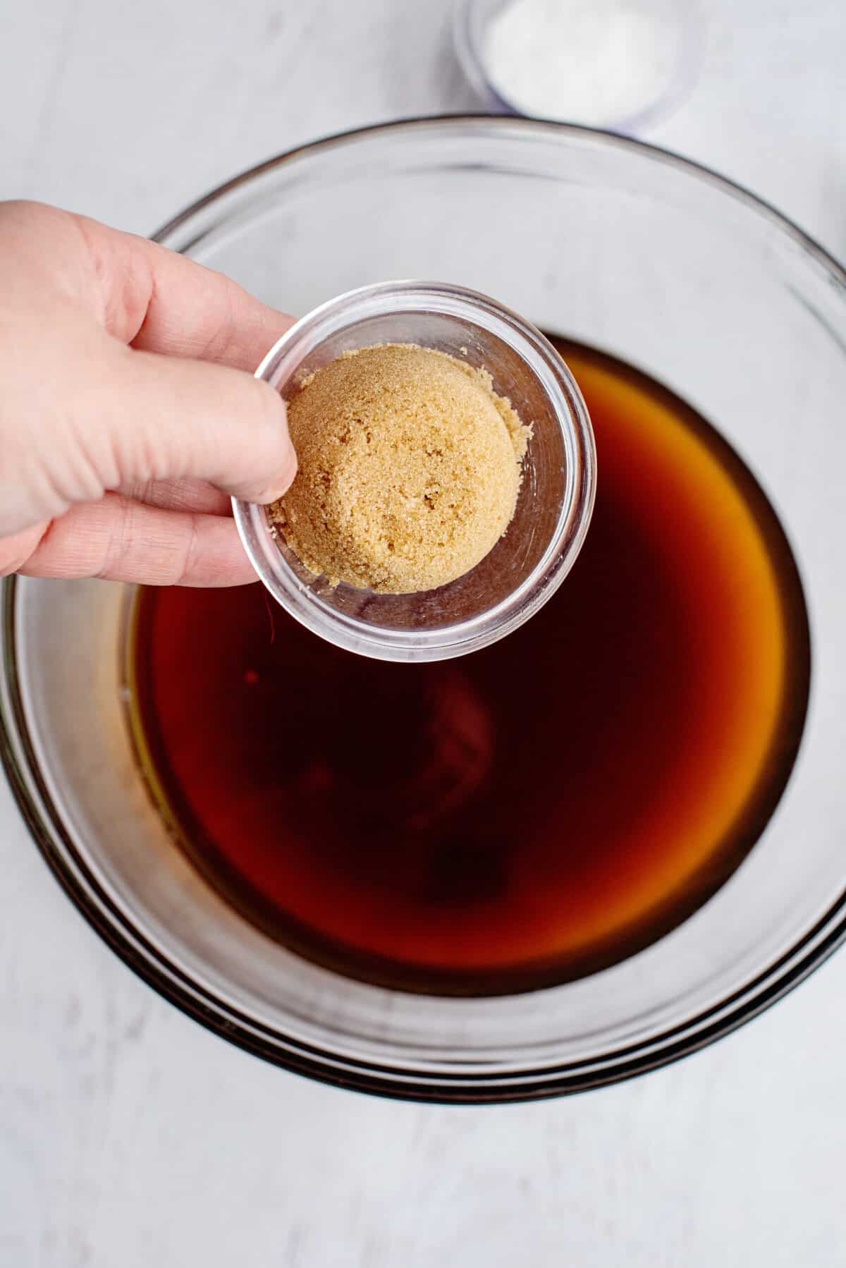 Adding brown sugar to the cooled sweet tea
