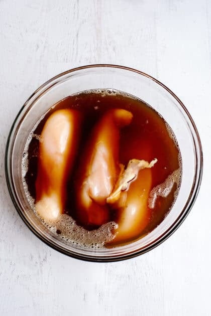 Coating the raw chicken in the sweet tea mixture