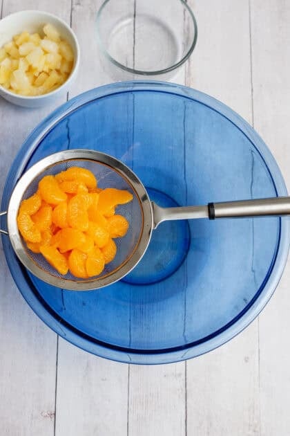 Draining the mandarin oranges