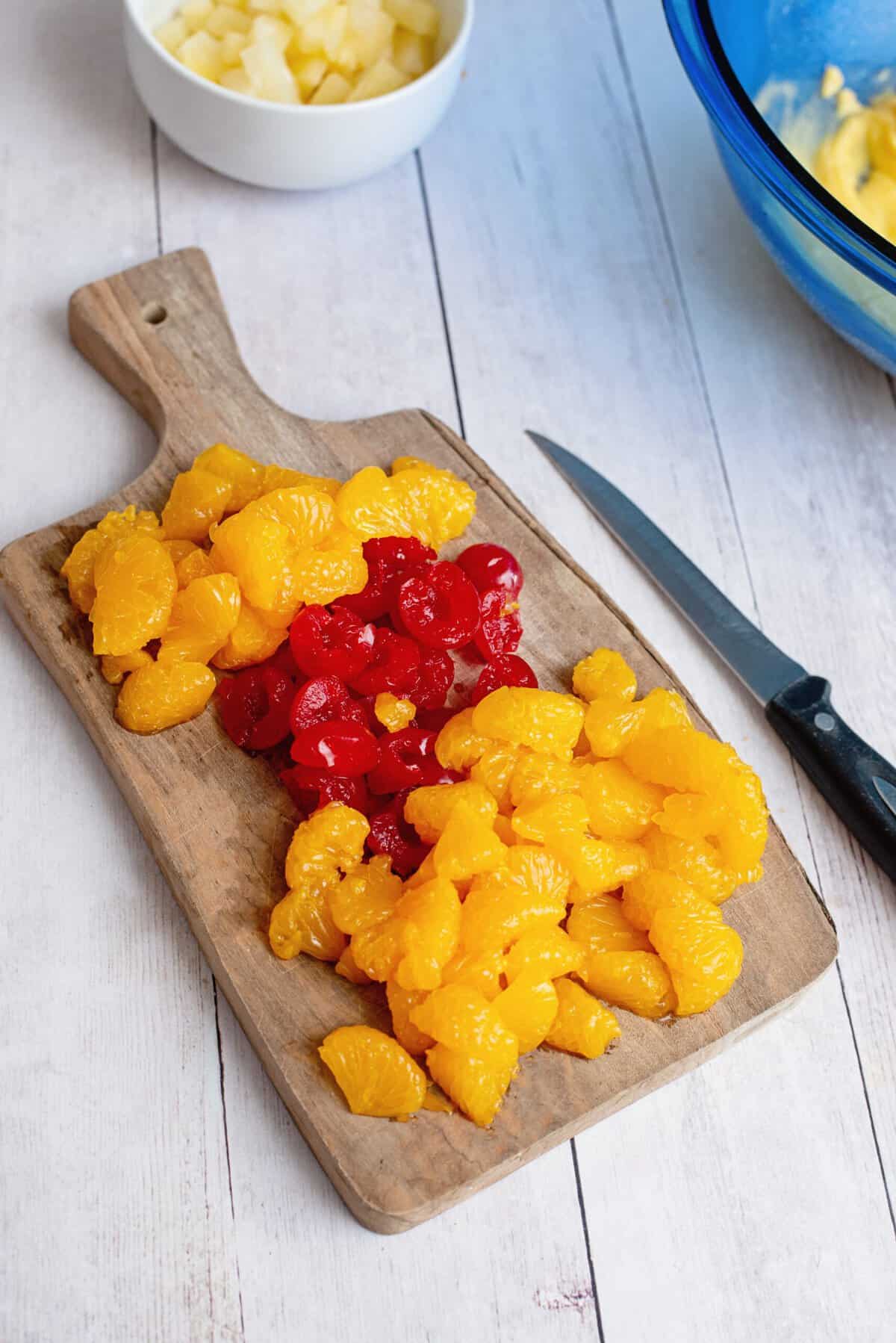 A cutting board with sliced fruit for the Whoa Horsey salad