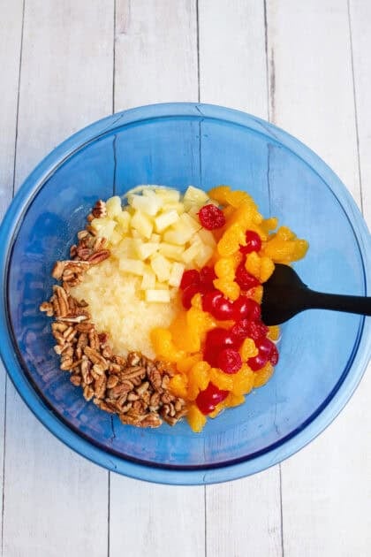 Combining the fruits and nuts in a bowl for Whoa Horsey salad