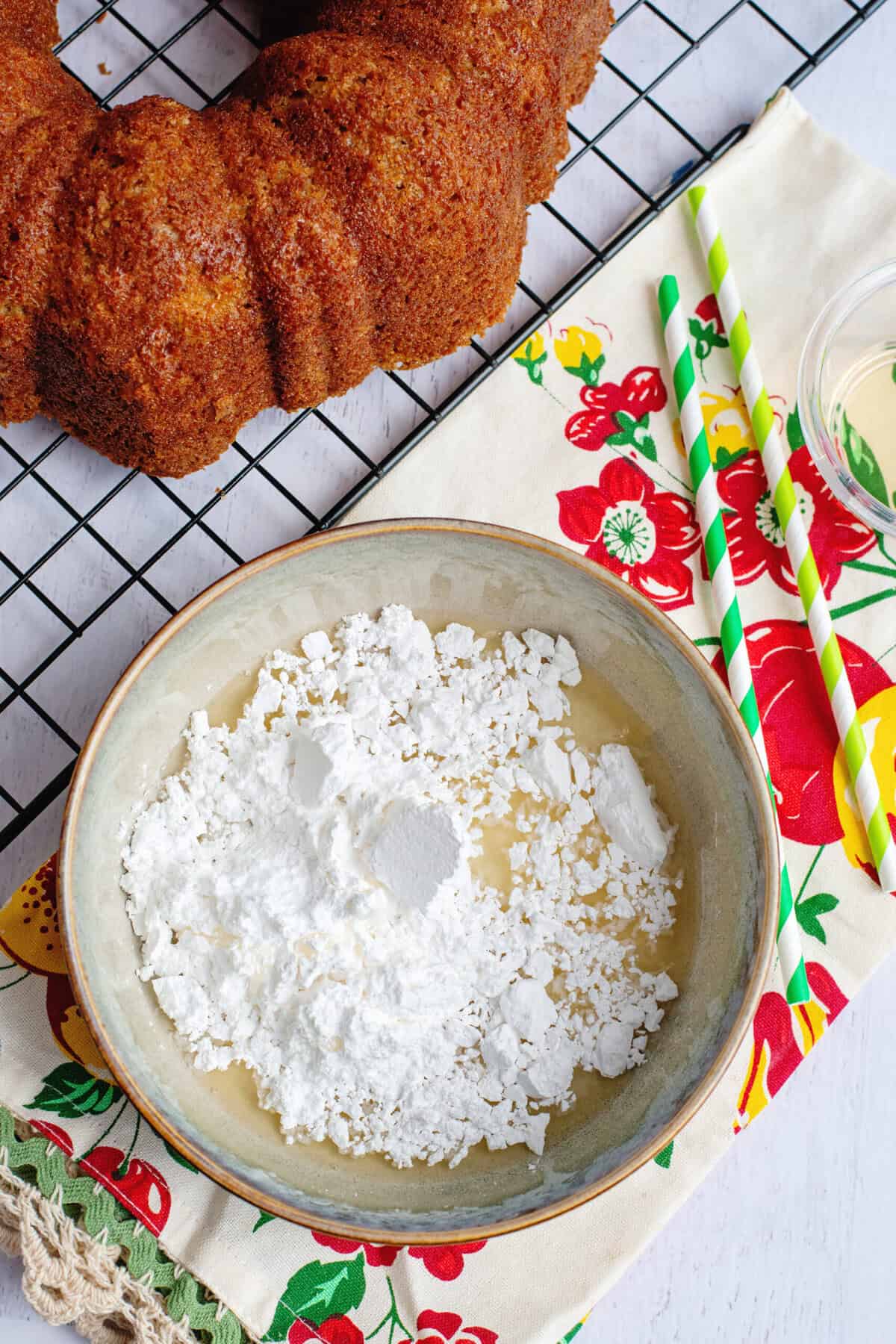 Powdered sugar, apple cider, and vanilla extract in a bowl.
