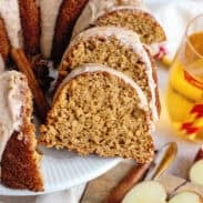 Sliced apple cider bundt cake on a cake stand.