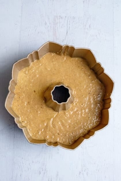 Apple cider bundt cake batter in a bundt cake.